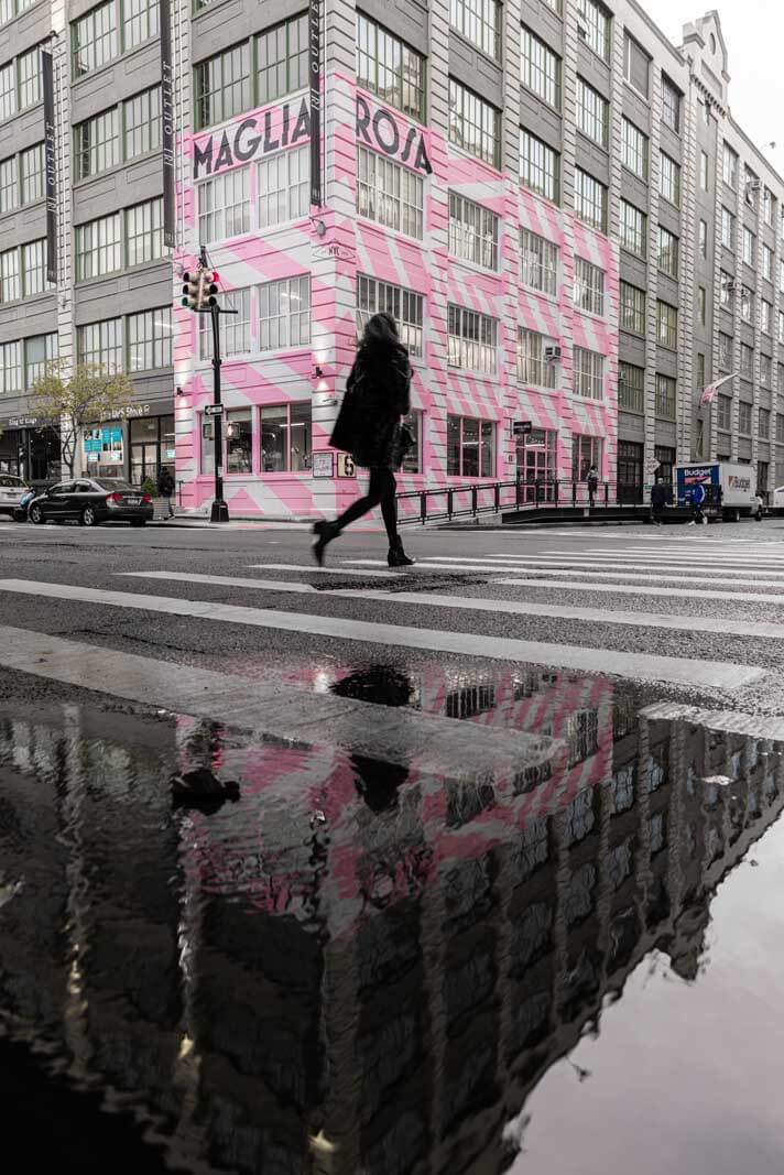 Woman crossing the street in front of Maglia Rosa at Industry City in Brooklyn