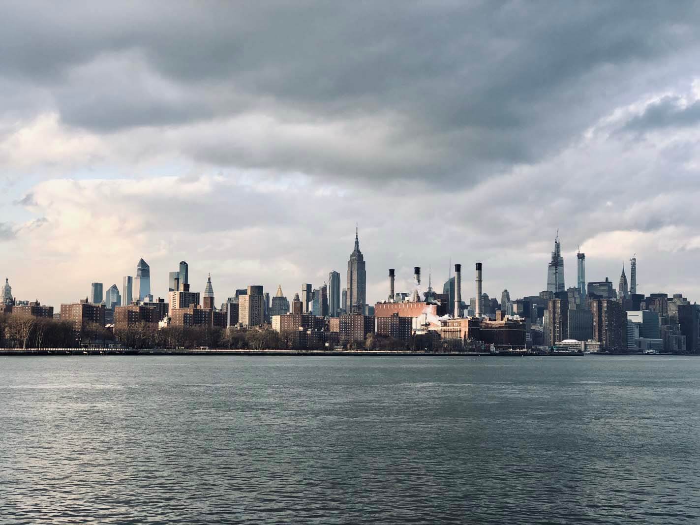 View of Manhattan with a bit of mood from Domino Park in Williamsburg Brooklyn