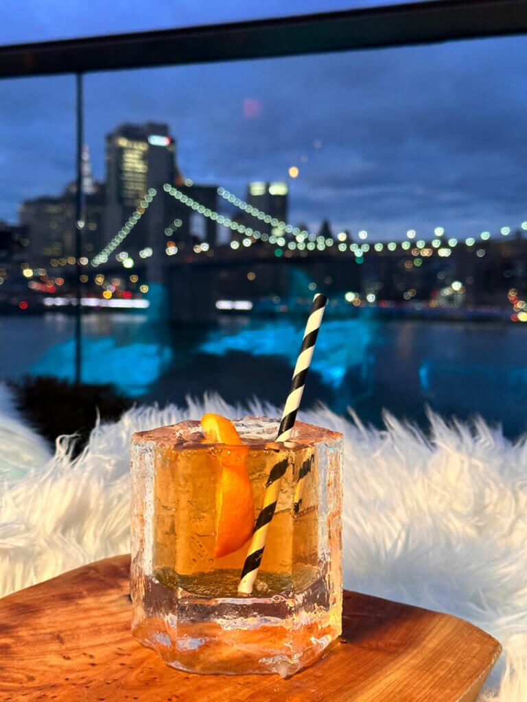 frozen-cup-and-cocktail-at-the-Polar-Lounge-from-Harriets-Rooftop-in-Brooklyn-with-the-night-skyline-view-in-the-backdrop