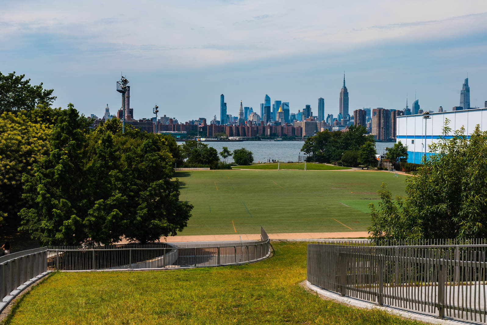 lawn and NYC skyline view from Marsha P Johnson Park formerly East River State Park in Williamsburg Brooklyn