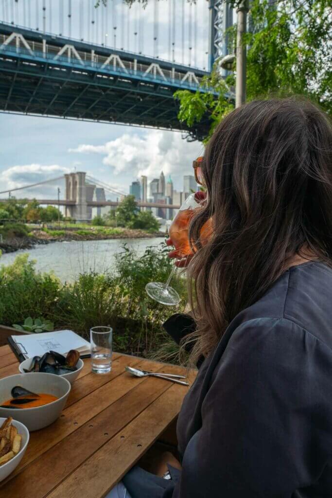 sipping on a spritz at Celestine looking at the Brooklyn Bridge in DUMBO Brooklyn