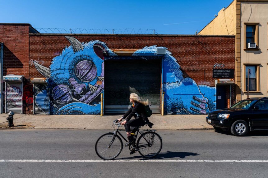 sleeping monster in Bushwick Brooklyn mural and cyclist