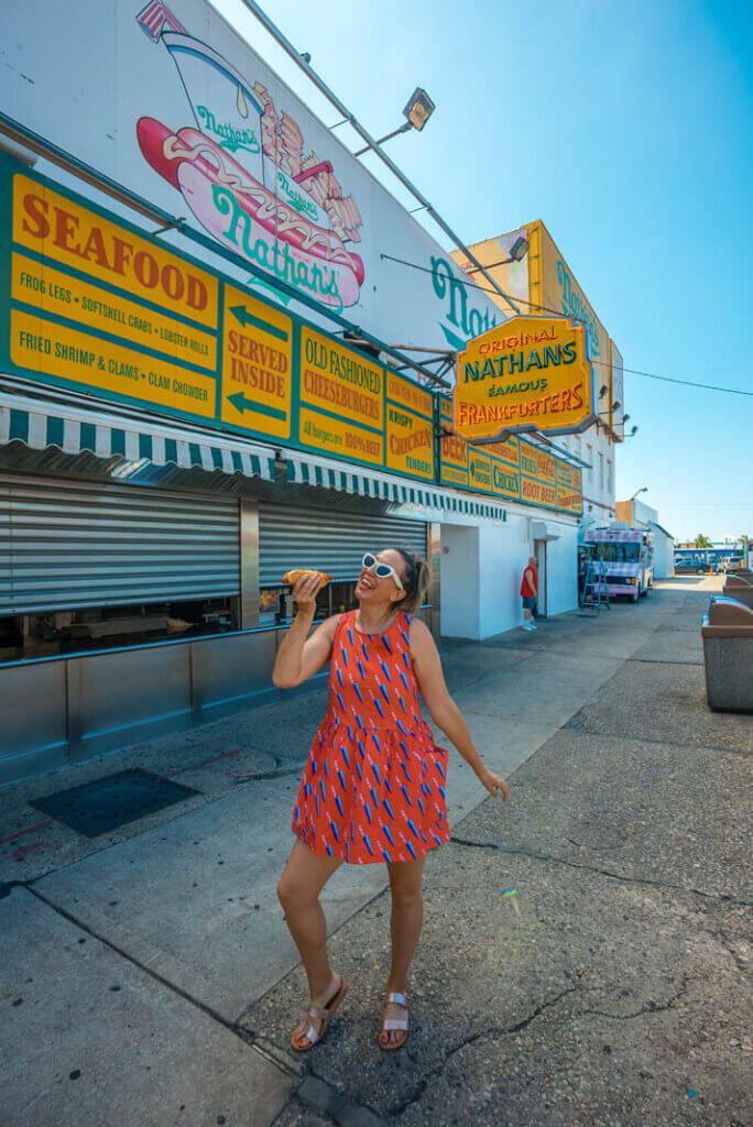 eating a Nathan's Famous hot dog at the original location in Coney Island Brooklyn