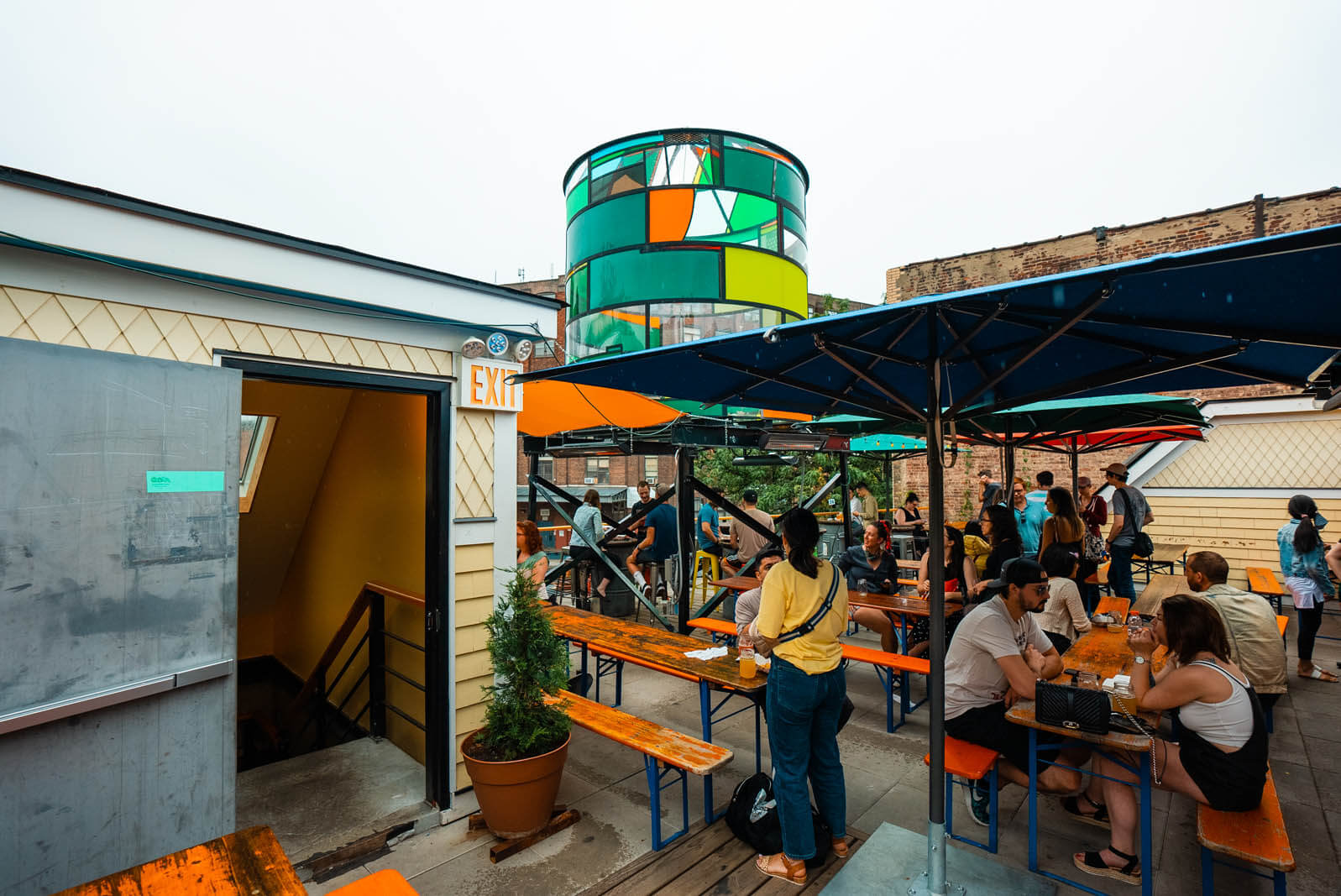 Greenpoint Beer and Ale Co outdoor rooftop seating area in Brooklyn plus glass watertower