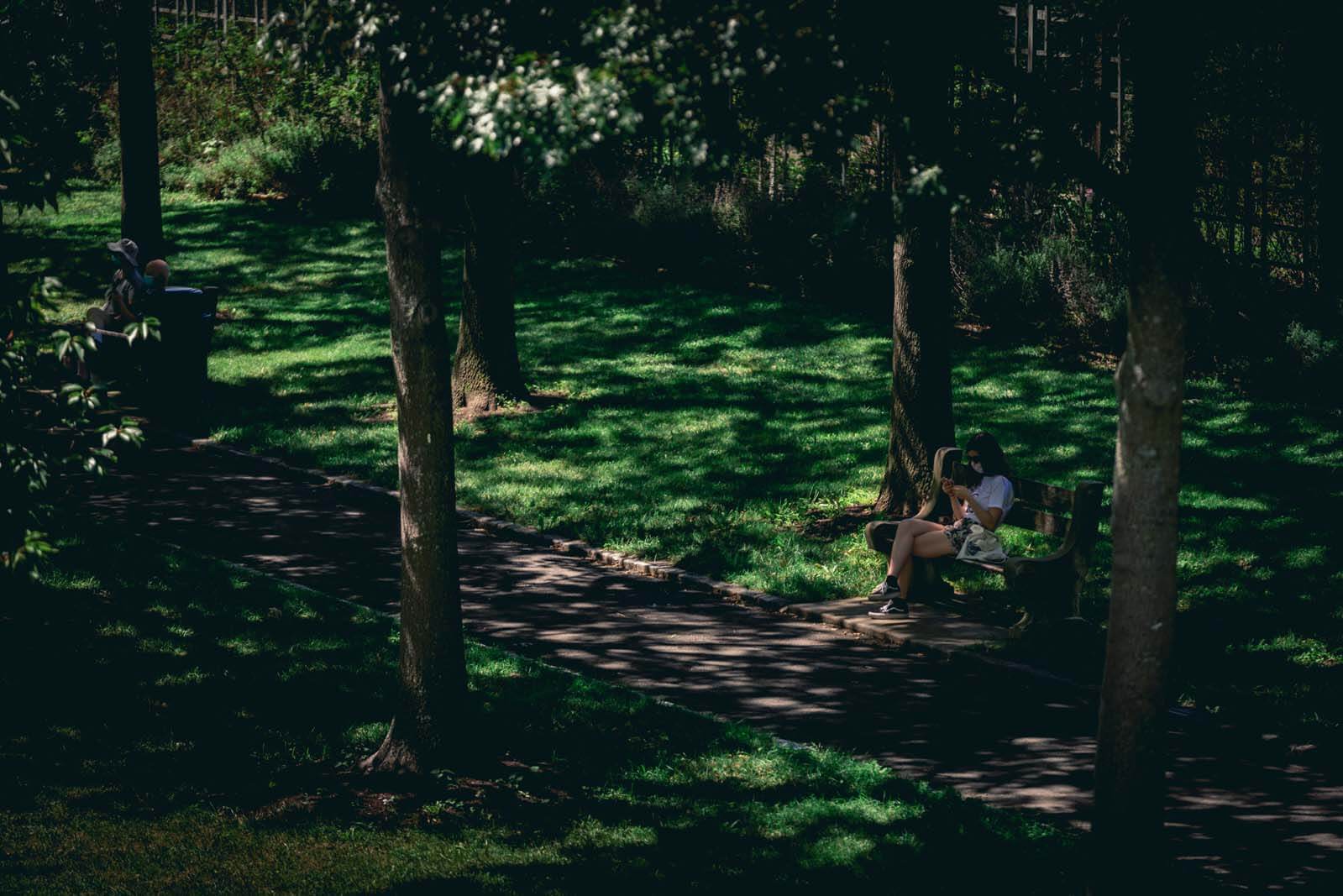 Woman relaxing at the cherry esplanade in Brooklyn Botanic Garden