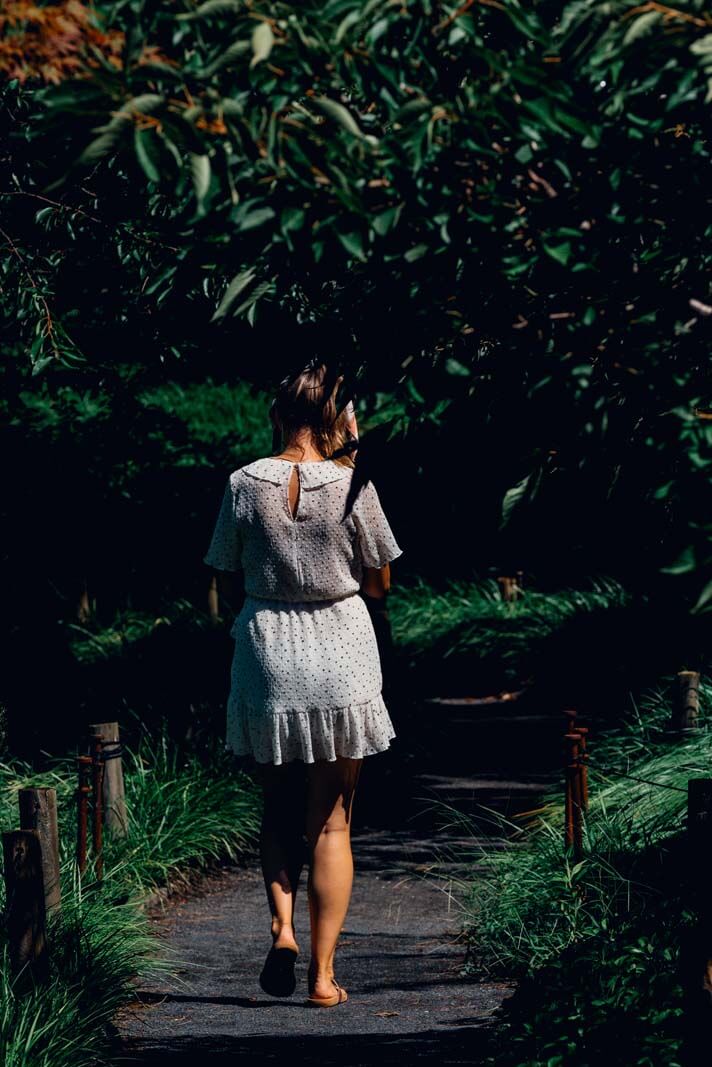 walking through a pretty grassy pathway in Brooklyn Botanical