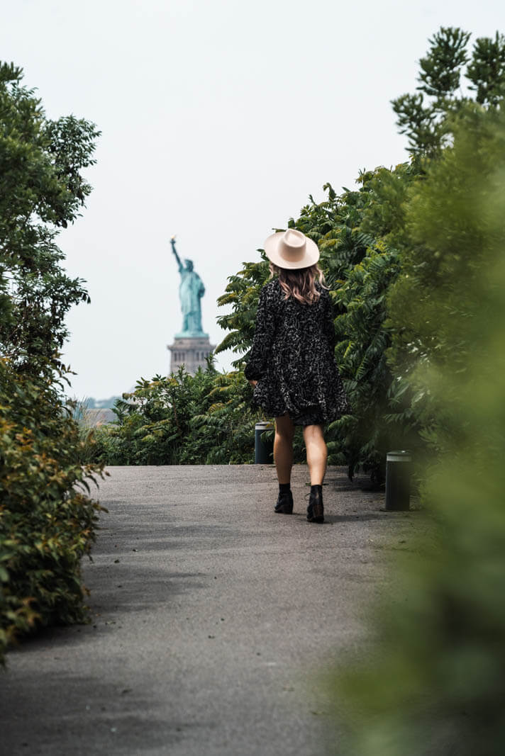 view of Statue of Liberty from the Hills pathway on Governors Island