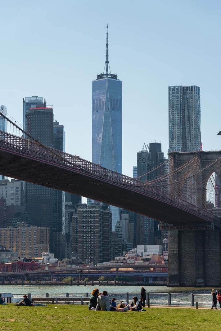 People enjoying a sunny day in Brooklyn Bridge Park Brooklyn New York