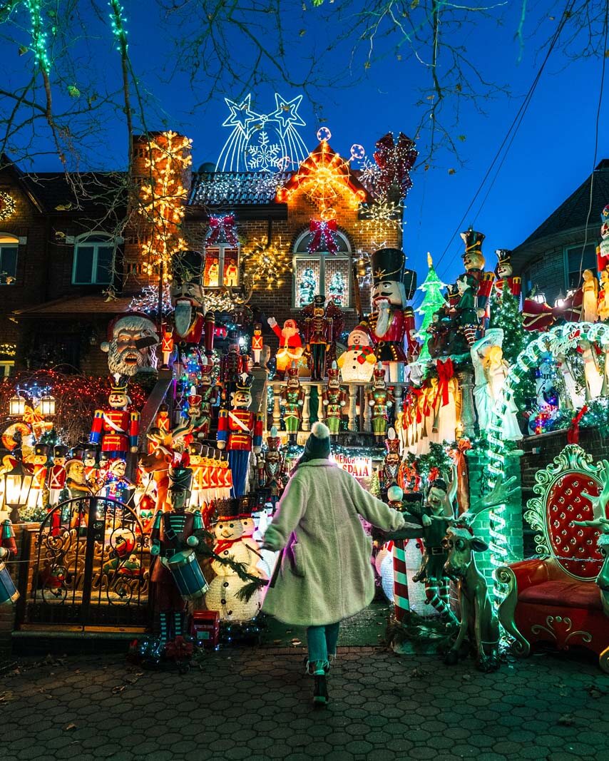 Girl posing in front of Lucy Spata house in Dyker Heights Christmas Lights