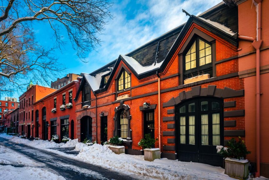 A row of Mew Carriage homes in Brooklyn Heights after snowfall