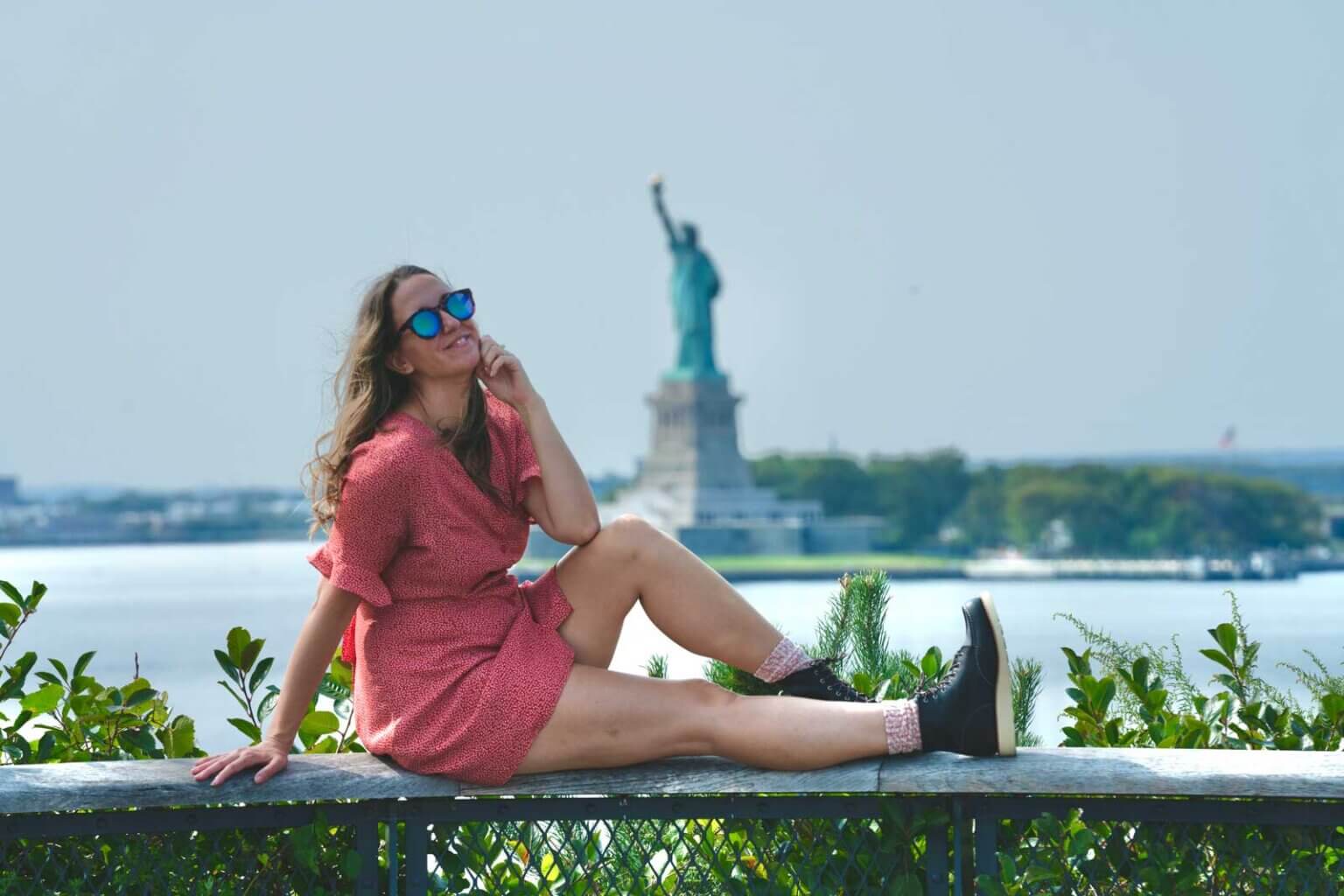 megan-at-the-hill-on-governors-island-in-nyc-with-the-statue-of-liberty-in-the-background