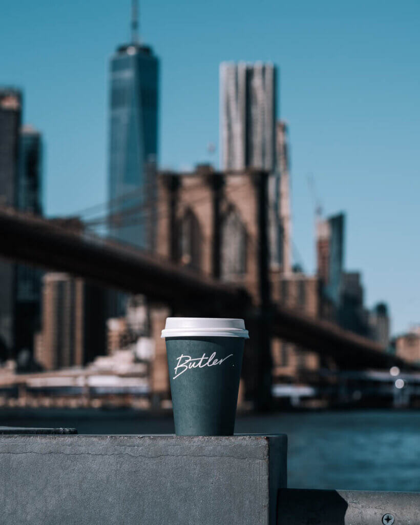 Butler Coffee with a view of the Brooklyn Bridge and city skyline in DUMBO Brooklyn