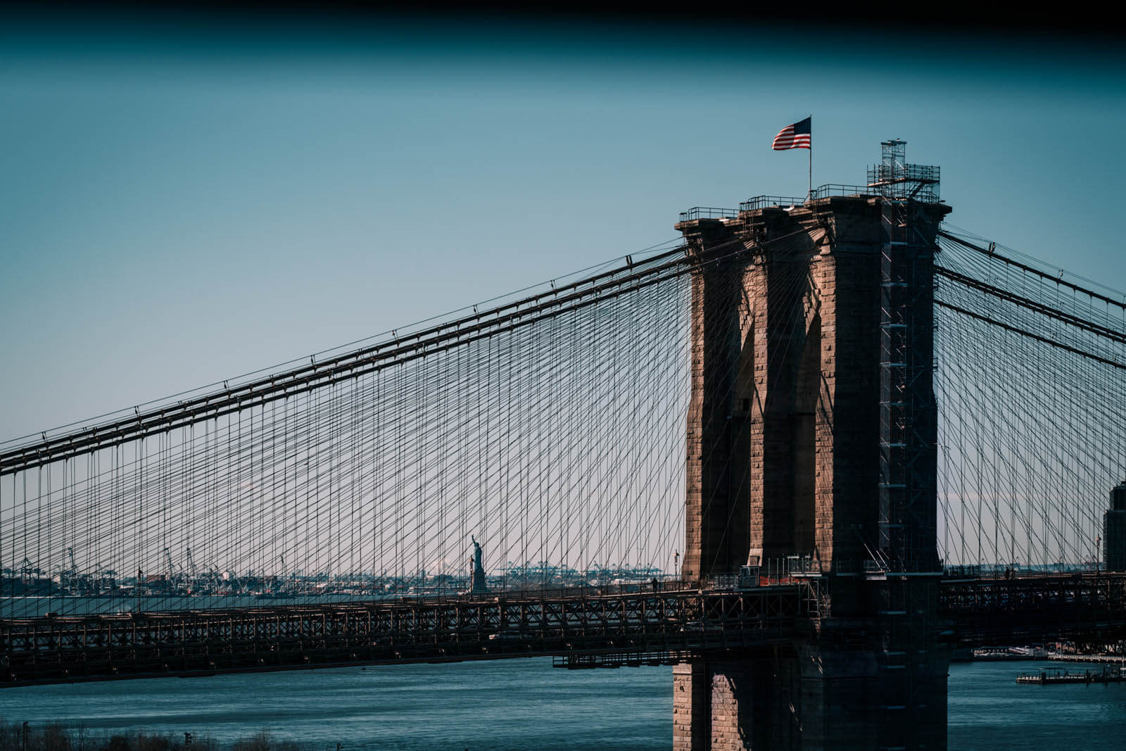 View of Statue of Liberty and Brooklyn Bridge from Manhattan Bridge in NYC