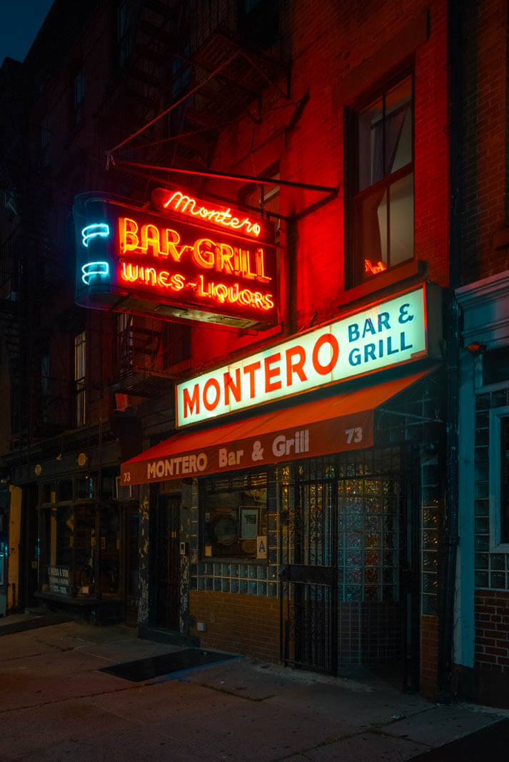 Montero's neon sign lit up at night in Brooklyn Heights on Atlantic Avenue