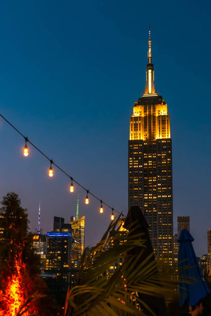 View of Empire State Building at night from 230 Rooftop in NYC