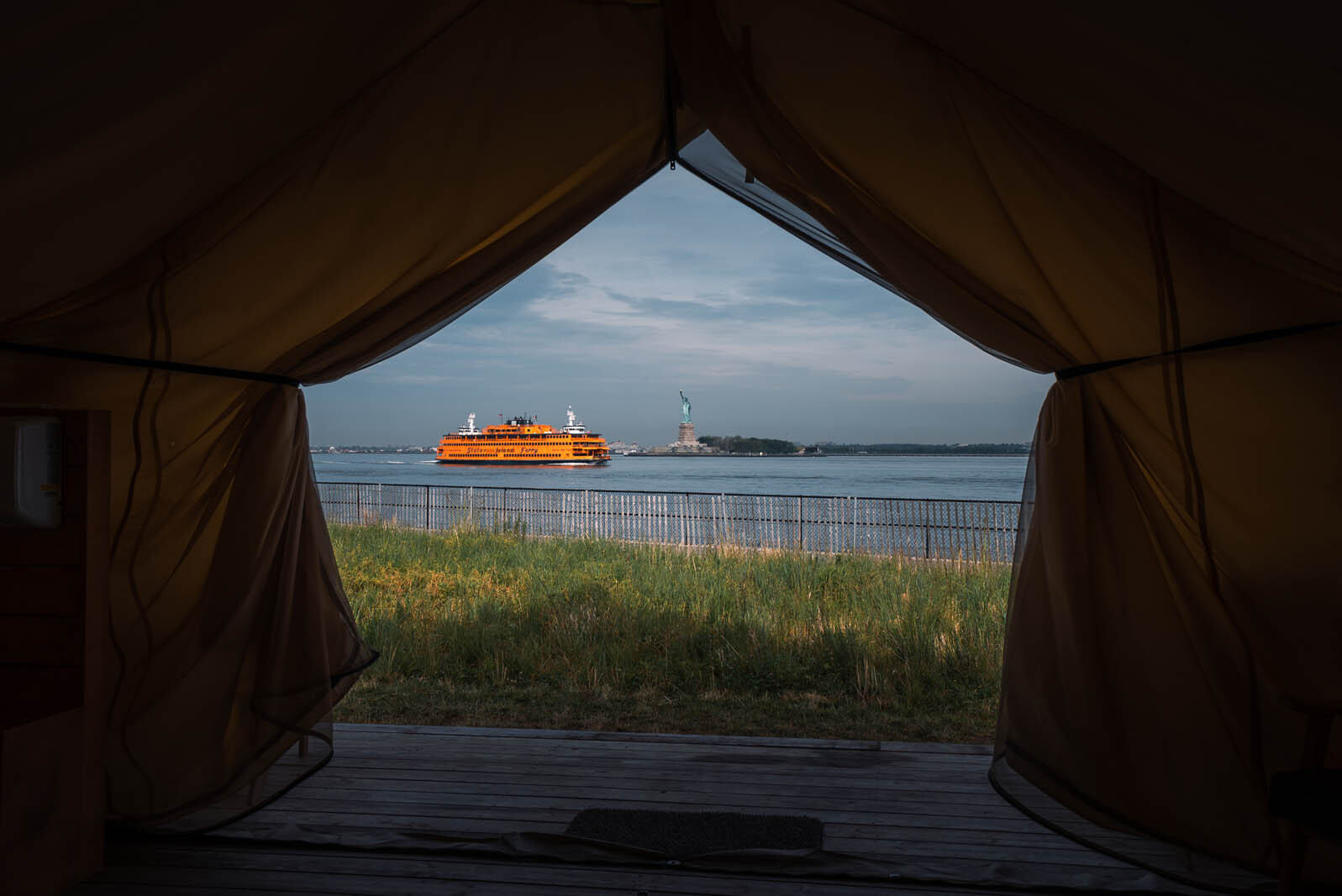 View of Statue of Liberty and Staten Island Ferry from Governors Island glamping