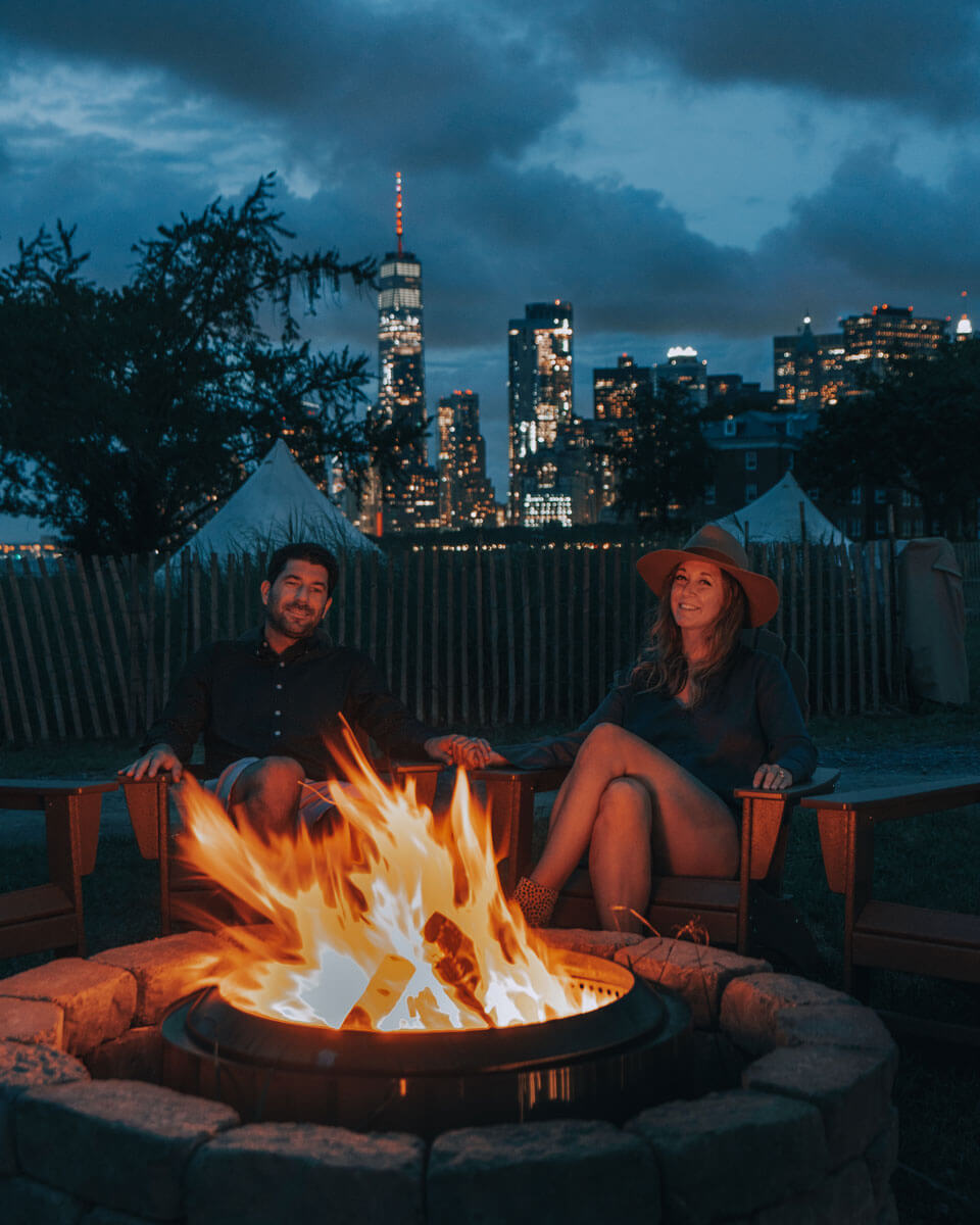 enjoying-the-fire-pits-at-collective-retreats-at-governors-island-with-view-of-the-world-trade-center