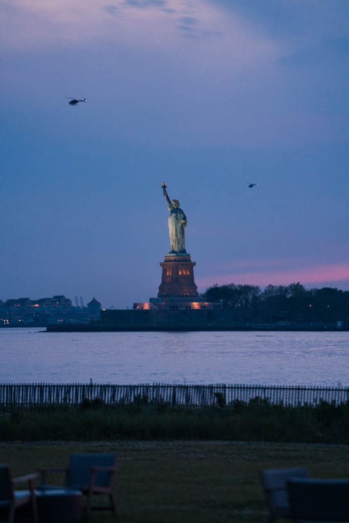 helicopters around Statue of Liberty view from Governors Island