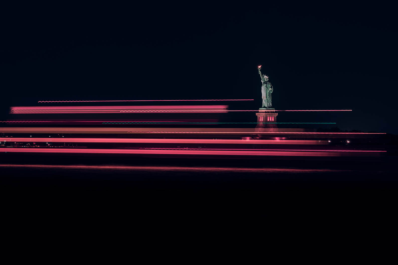 pink neon streaks from the boats passing the statue of liberty