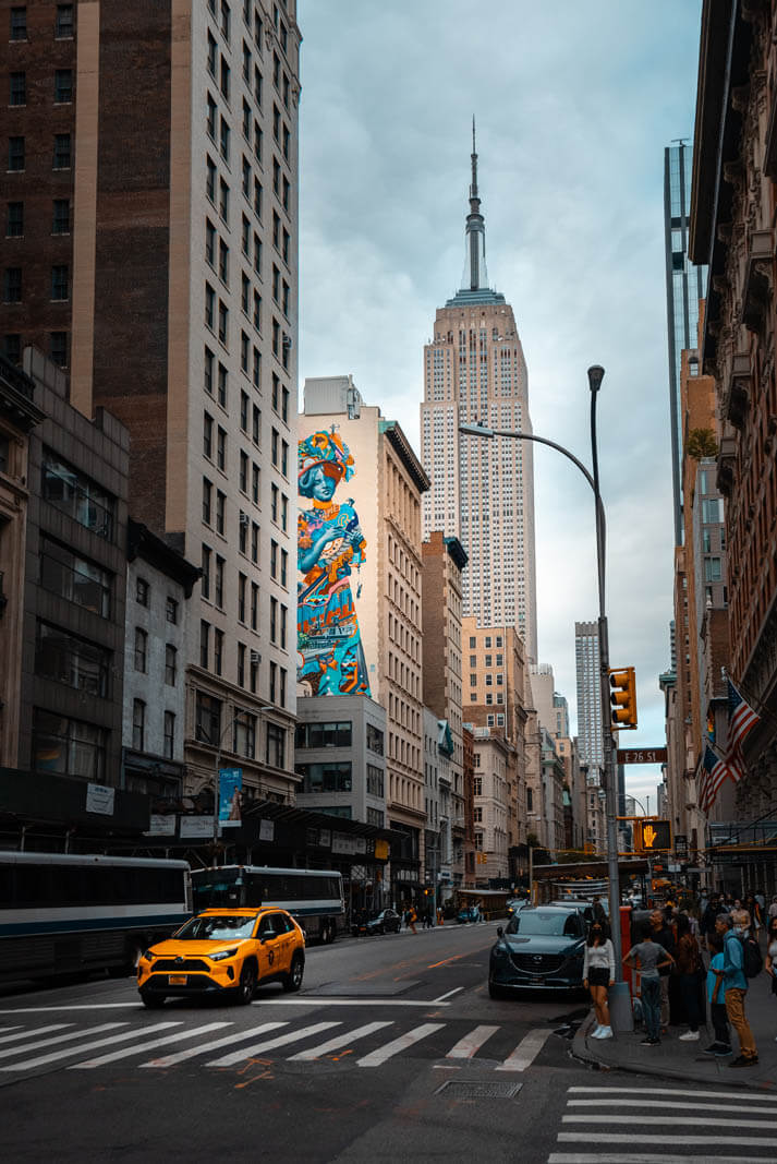 5th Ave near Madison Square Park in NYC view of Empire State Building and mural