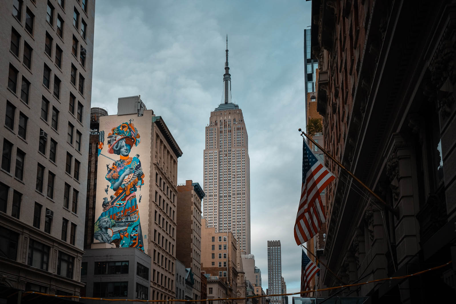 Empire State Building view with Mural on 5th Ave in NYC