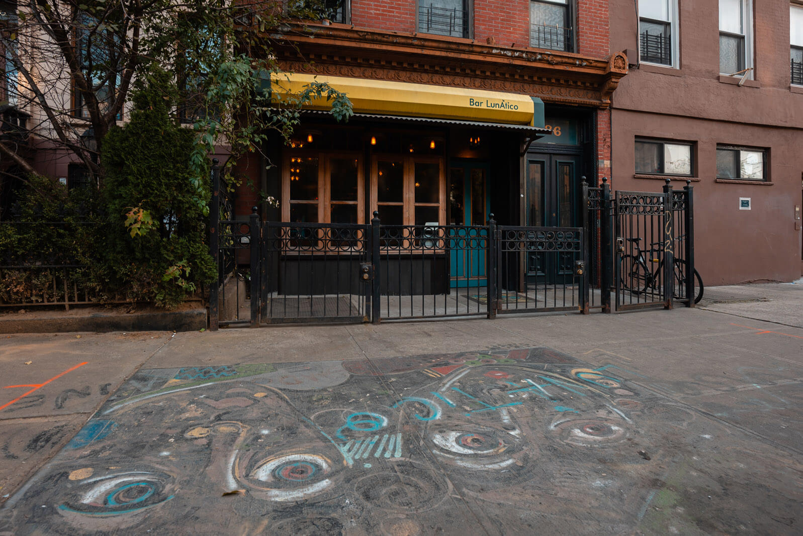 Bar LunAtico exterior and aine sidewalk art in Bed Stuy Brooklyn