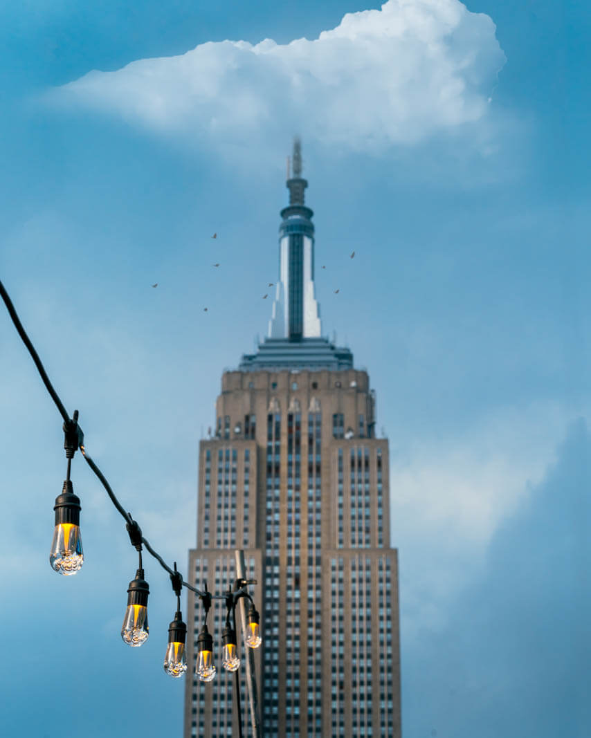 top of empire state building from 230 rooftop bar in nyc