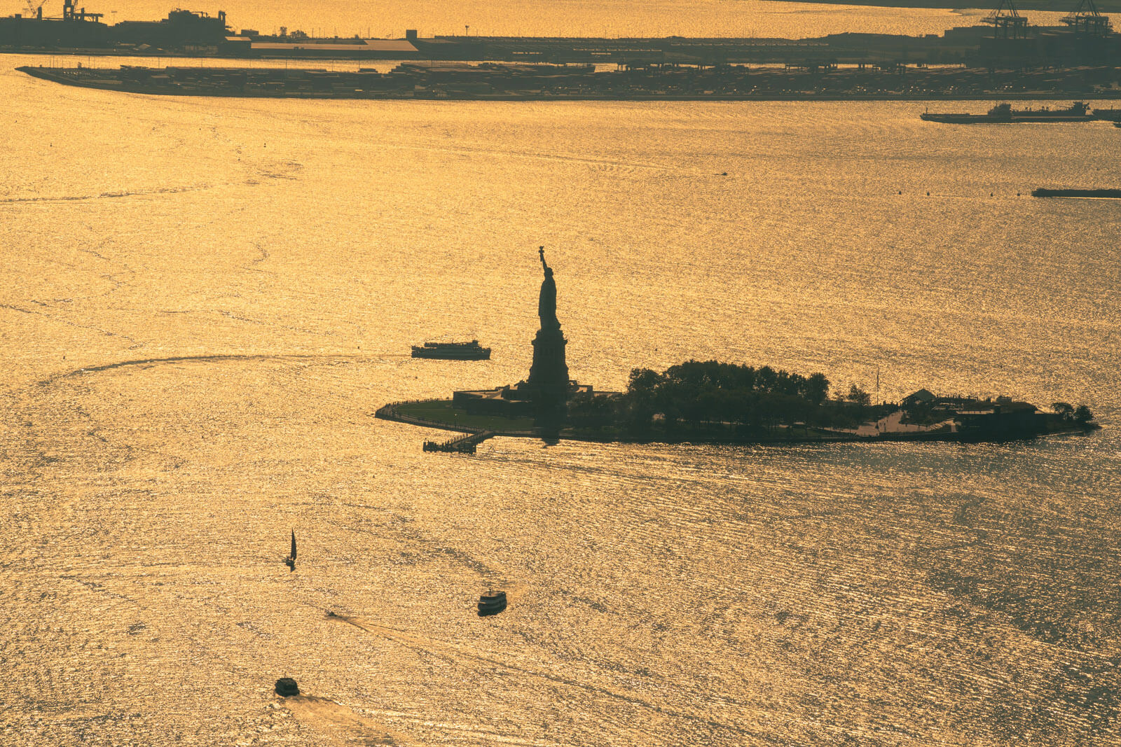 View of Statue of Liberty from one world trade center observatory in NYC in New York Harbor