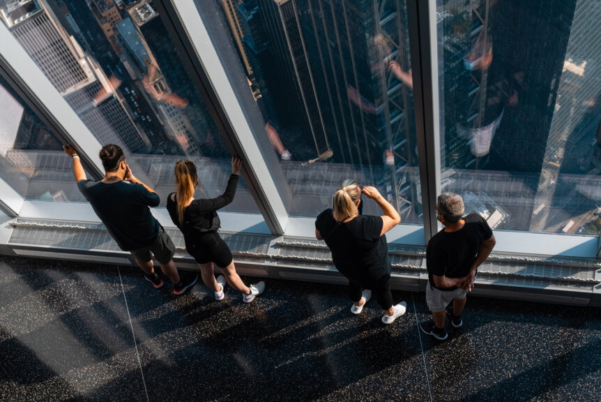 Visitors enjoying the view from One World Trade Observatory in NYC