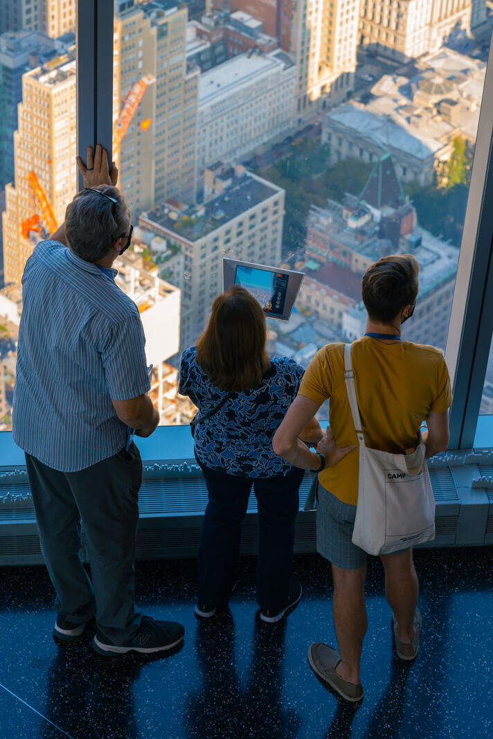 visitors using the digital explorer at one world trade center and freedom tower observatory in NYC