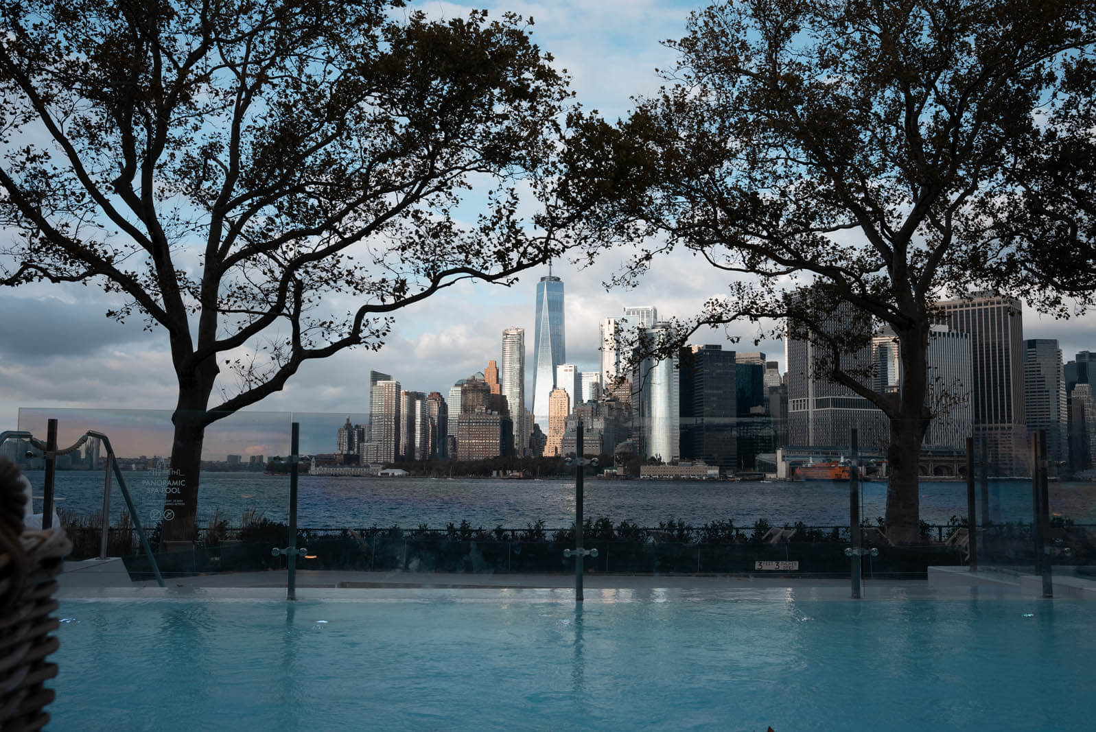 QCNY Spa outdoor heated pool on Governors Island with a view of the World Trade Center and city skyline