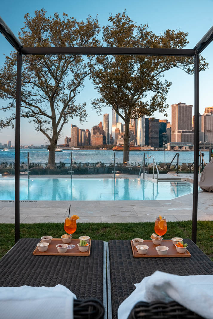 spritz and snack at QCNY Spa with skyline view at Governors Island in NYC