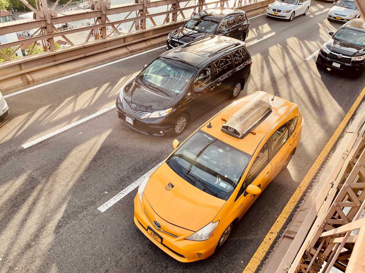 cars-driving-over-the-brooklyn-bridge-in-nyc-during-the-day-including-a-taxi