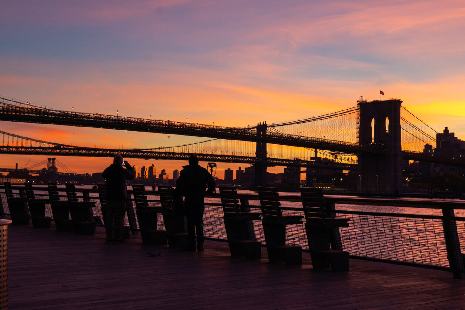 sunset view of the Brooklyn Bridge from Pier 17 in South Street Seaport in NYC
