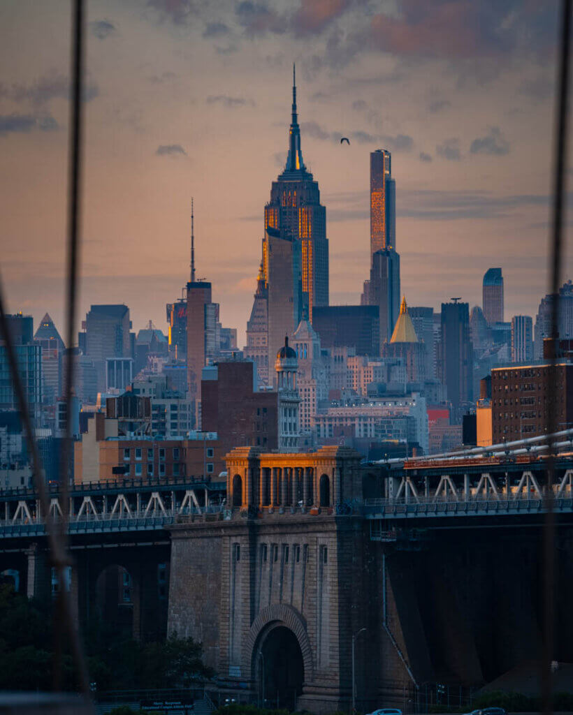 view of the Empire State Building at sunset from the Brooklyn Bridge walk in NYC