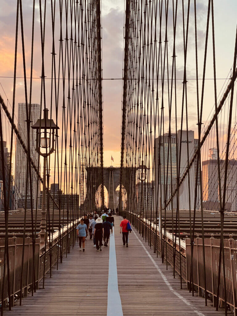 walking-the-brooklyn-bridge-is-one-of-the-best-outdoor-activities-in-NYC-at-sunset