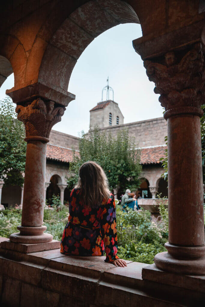 sitting and looking at the gardens inside the Met Cloisters in Washington Heights in NYC