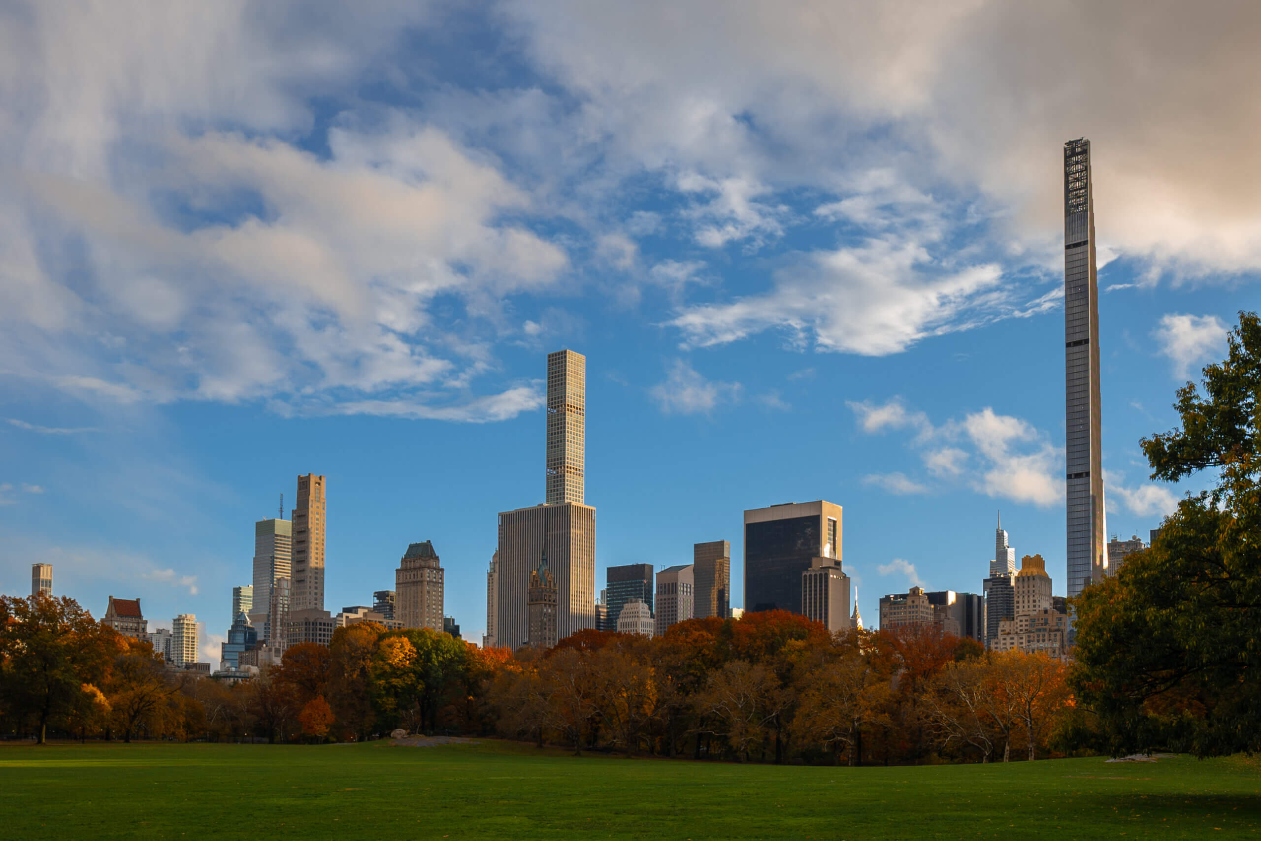 Sheep Meadow in Central Park during the fall with the city skyline in the background in NYC