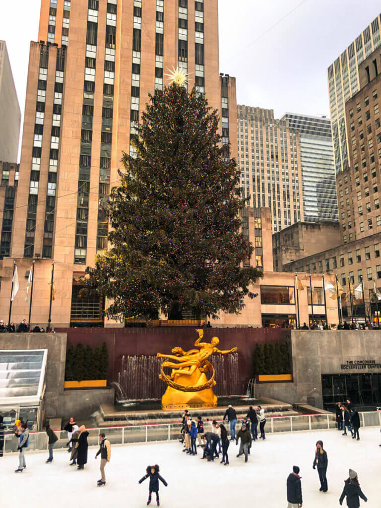 The-Rockefeller-Christmas-tree-overlooking-the-rink-at-rockefeller-center-during-the-holidays-in-New-York-City