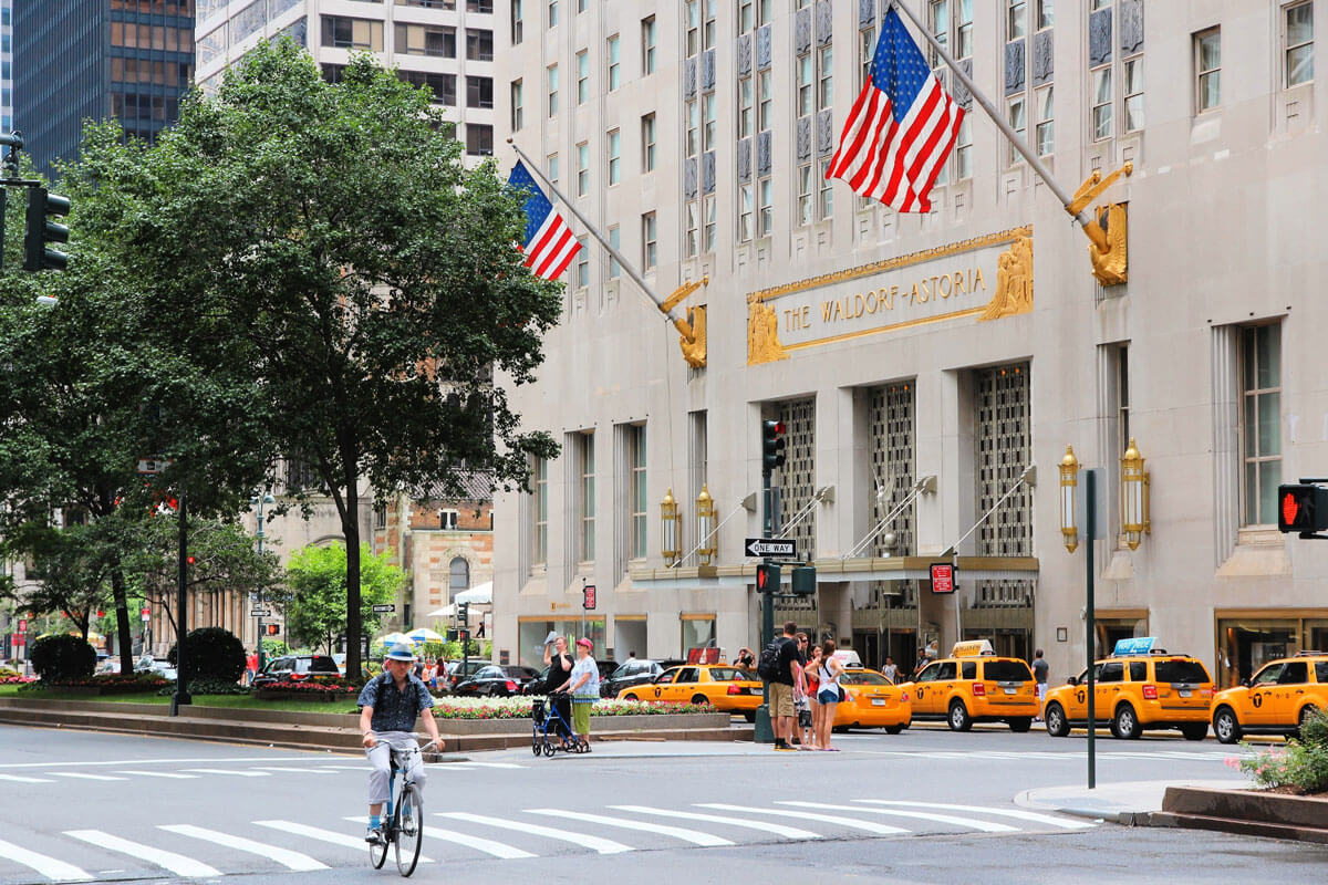 Waldorf-Astoria-New-York-with-taxis-and-cyclists-in-NYCWaldorf-Astoria-New-York-with-taxis-and-cyclists-in-NYC
