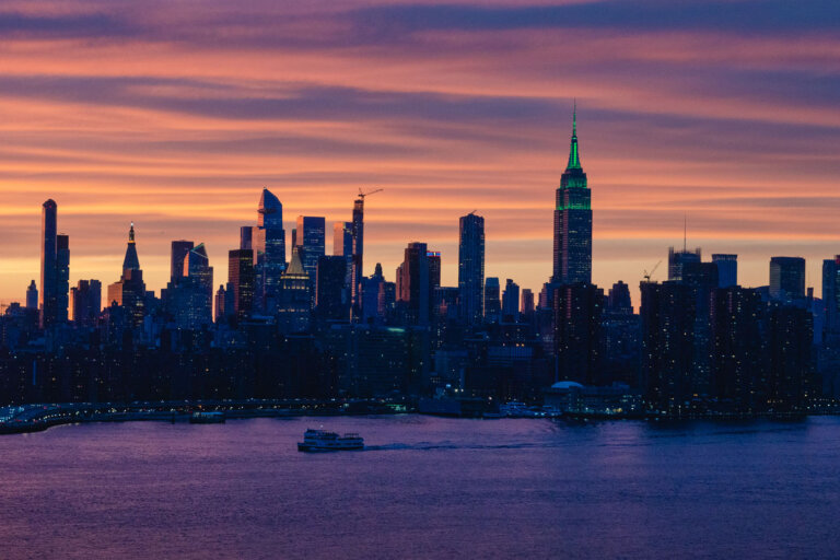 view of the NYC skyline at sunset from the water tower bar rooftop bar at Arlo Williamsburg in Brooklyn